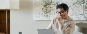 a person sitting in front of a laptop computer