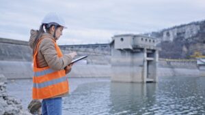 Female working by a body of water