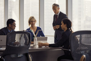 Men and women in in open workspace in office
