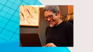 A woman smiling working on a laptop. The image is overlaid on a blue and gray graphic design background.