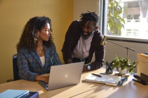 Two education leaders collaborating in an office at a higher education institution.