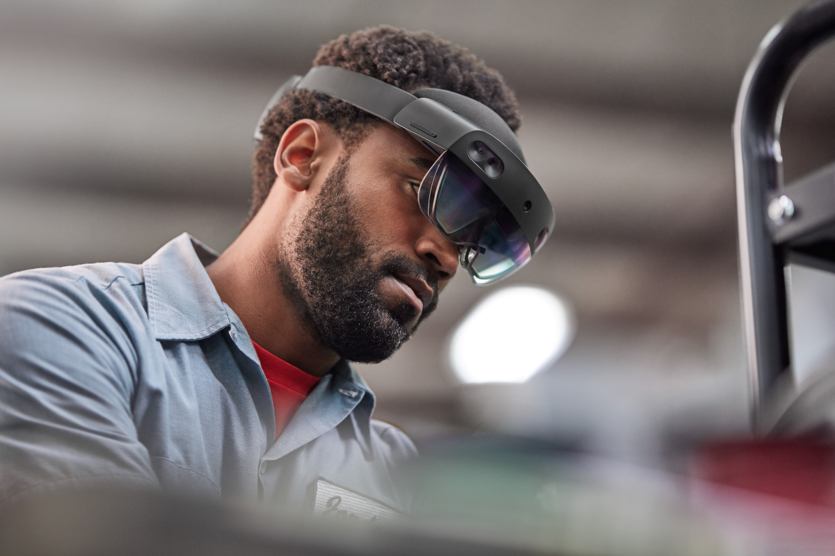 Man using Dynamics 365 Guides to assemble a generator. Lifestyle photography. Contextual imagery.