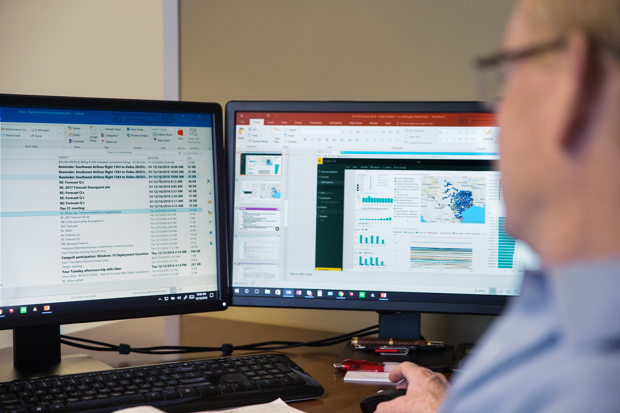 Working on two screens, reviewing data.