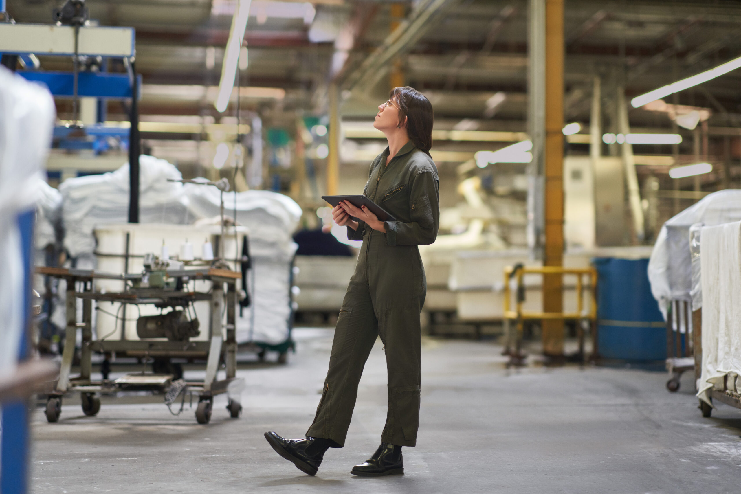 A person standing in a textile warehouse.