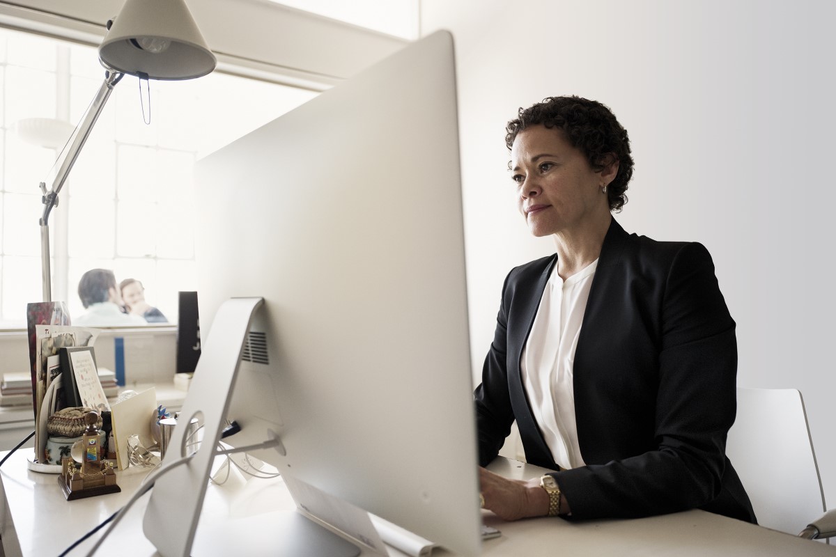Business woman in office with Desktop PC