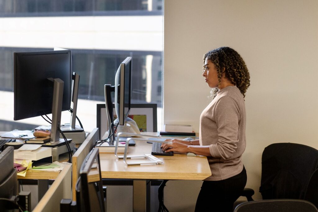 A person working at a standing workstation.