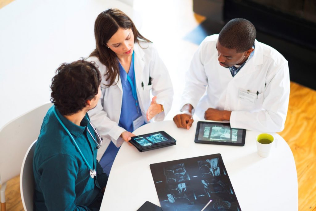 Doctors sharing information on tablets using an application