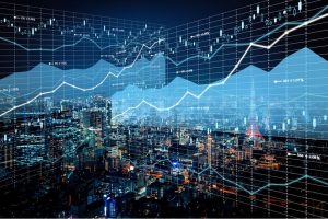 Cityscape at night with graph and bar chart image overlaying the photograph