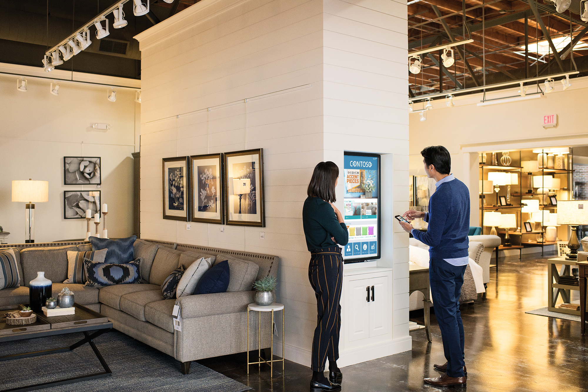 Two people using device in retail store