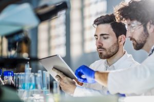 Two scientists using digital tablet in laboratory