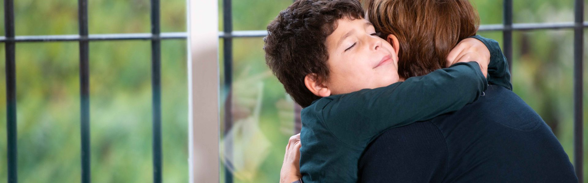 Adult hugging child