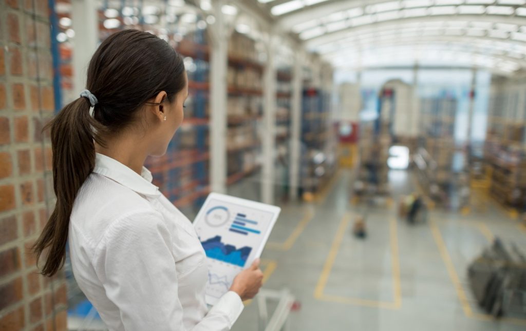 Person looking at device while working in a factory