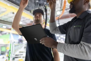 two people looking at computer parts holding a tablet