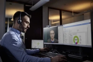 a man standing in front of a computer screen