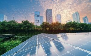 Solar panels in the foreground, city skyline in the background.