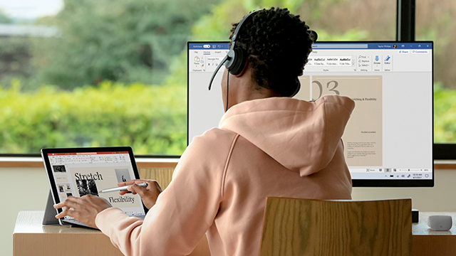 man with headphones working on his laptop