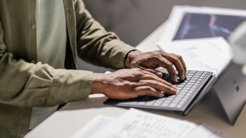 A person typing on a keyboard
