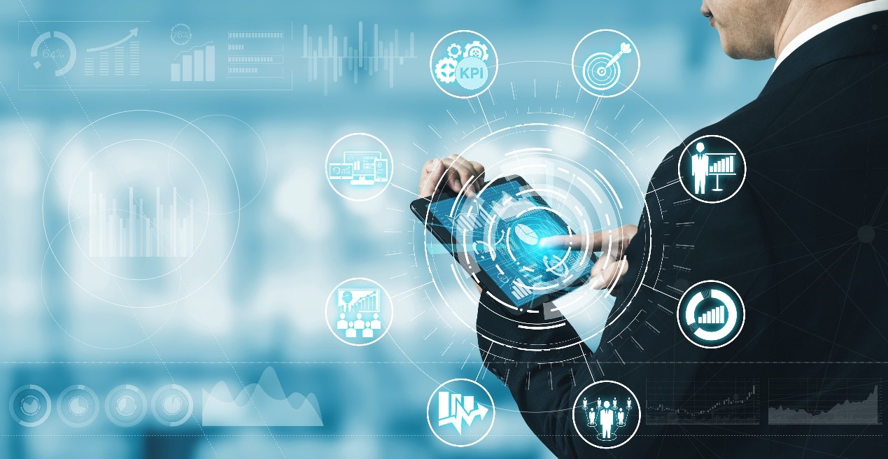 Man in a suit holds a tablet in his hand. Graphic images of information circles around it