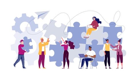 a group of business people work together on a puzzle