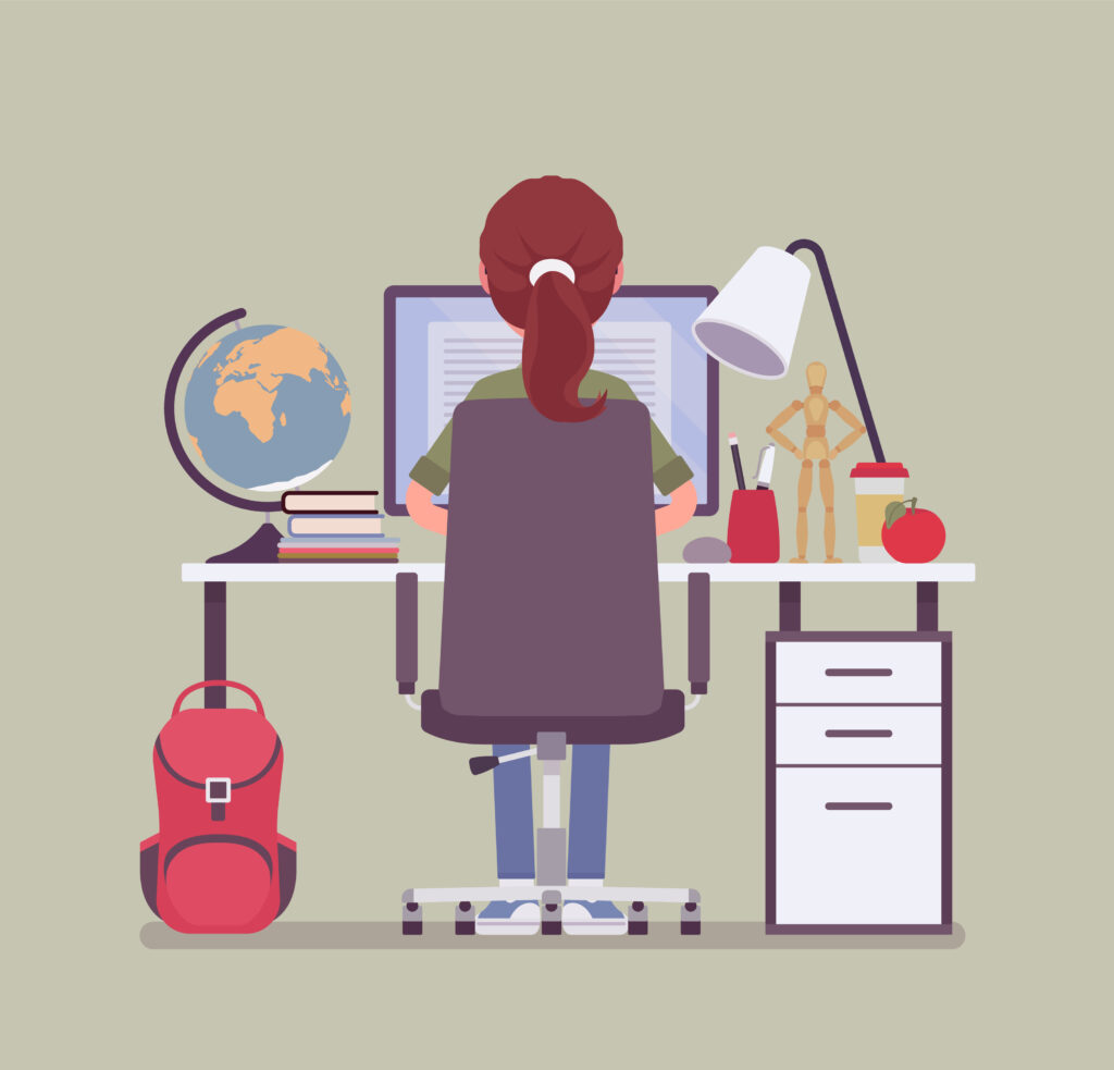 female student sitting at a desk with a computer