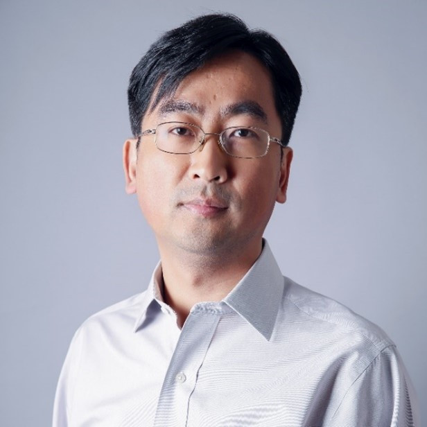 a man wearing glasses posing for the camera