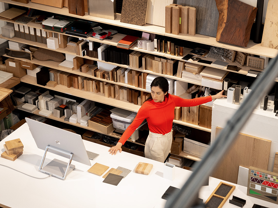 Contextual image of woman working on Surface Studio2 inside office