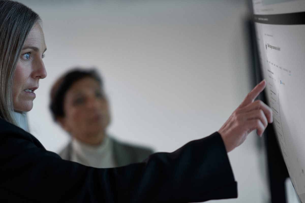 C I S O collaborating with a practitioner in a security operations center.