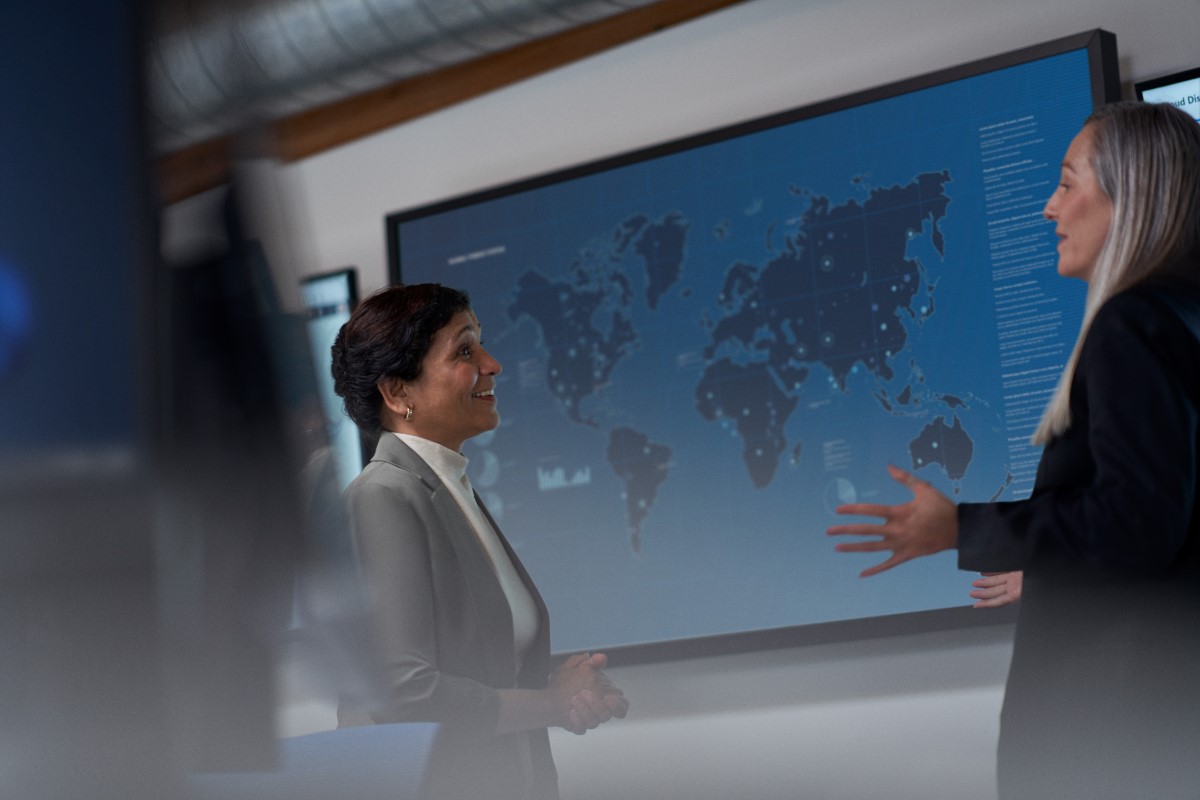 Chief information security officer collaborating with a practitioner in a security operations center.