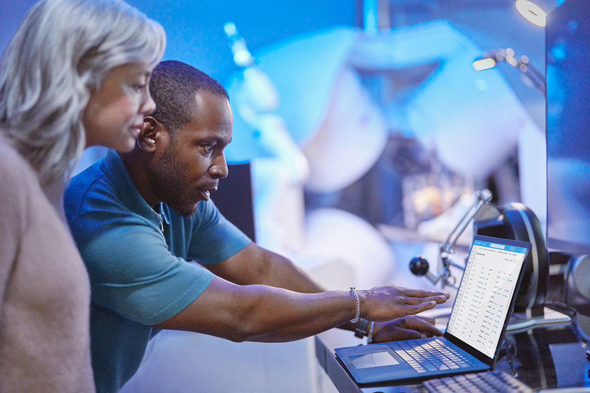 Photo of medical researchers collaborating and using technology to review medical research insights.