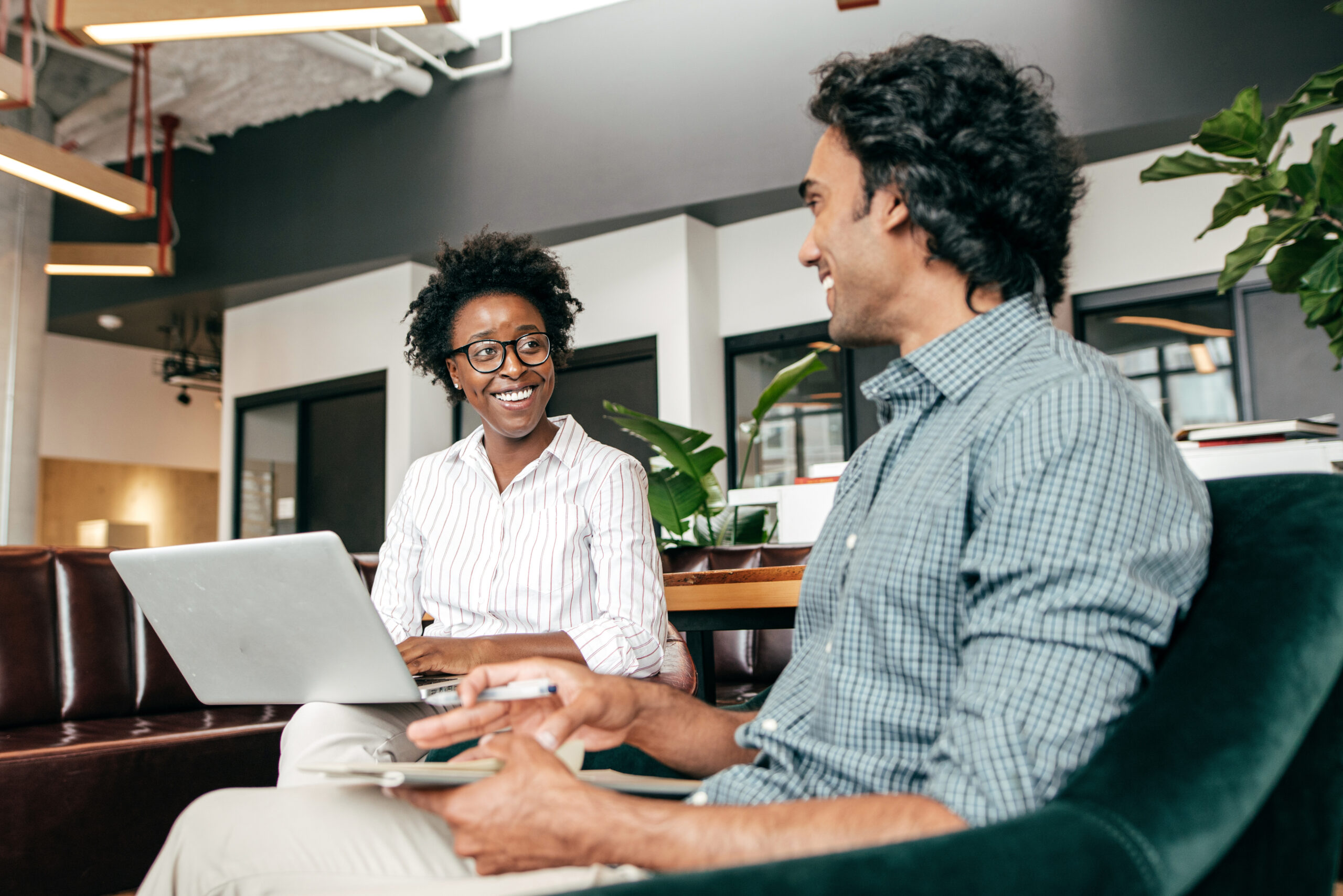 marina arnaout article featured image: Two entrepreneurs relax in a casual office and discuss strategy.