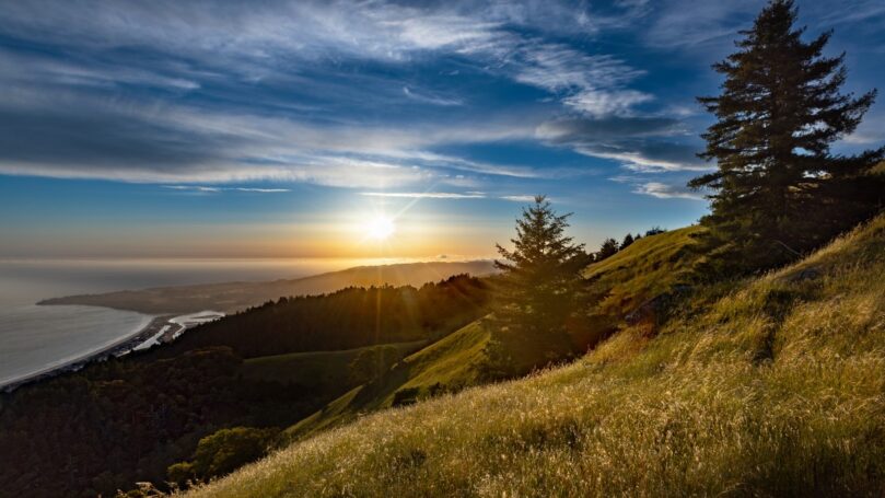 Expansive view of ocean coast at sunset across the foothills in Mount Tamalpais State Park, Mill Valley, California