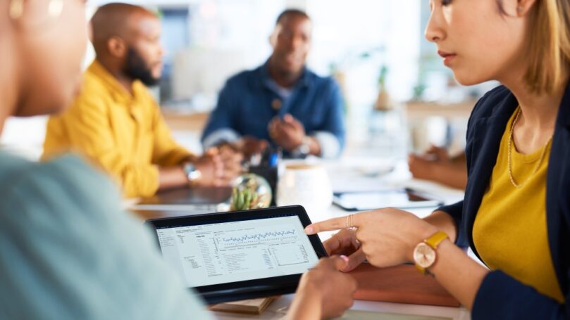 Tablet, graphs and teamwork of women on data, infographic review and dashboard logistics.