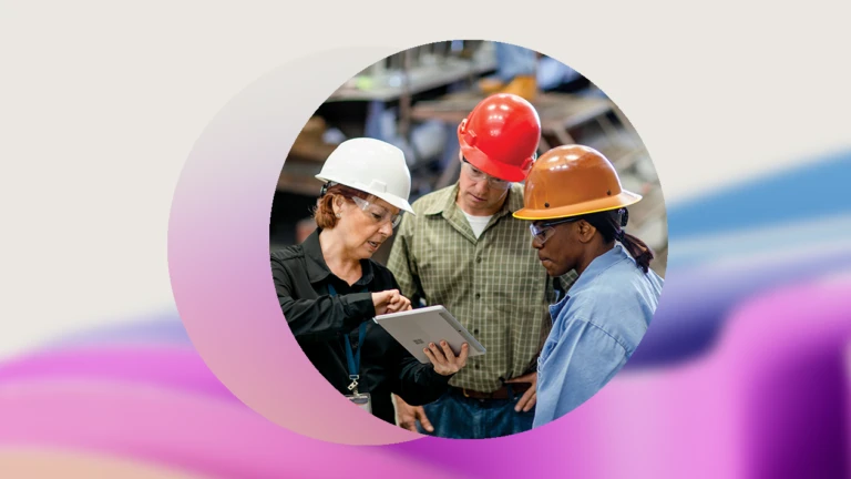 Decorative image of people working together in a warehouse wearing hardhats.