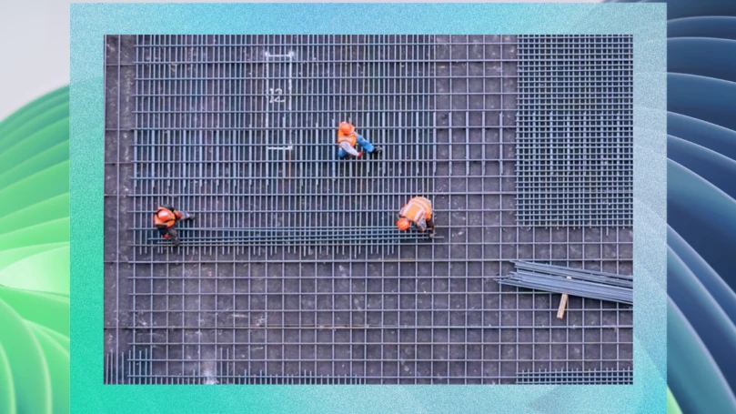 Aerial view of construction workers in on a foundation of rebar.