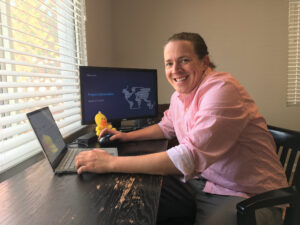 Jeff Cluff looks up and smiles from his desk in his home office.