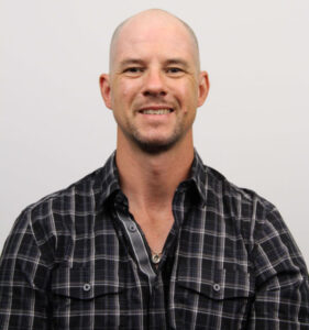 Dellenbaugh looks at the camera in a closeup photo.