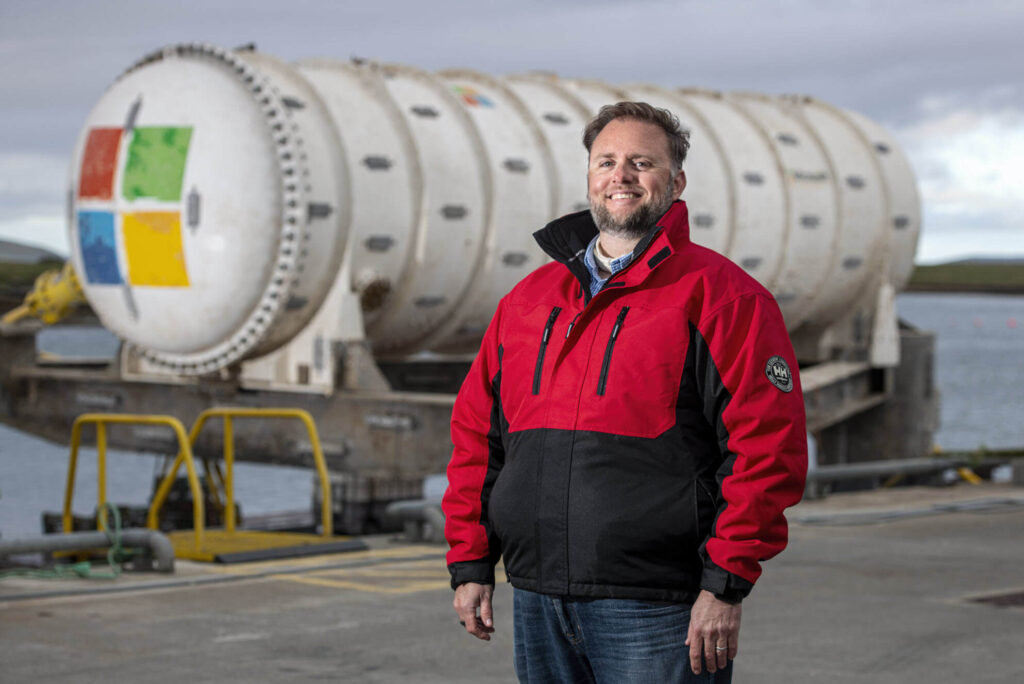 Shepperd stands in front of the underwater datacenter after it was retrieved from the sea.