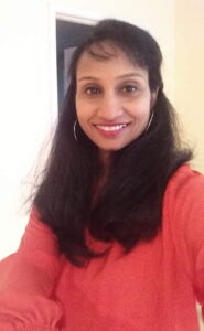 Soumya Subramanian looks at the camera and smiles.