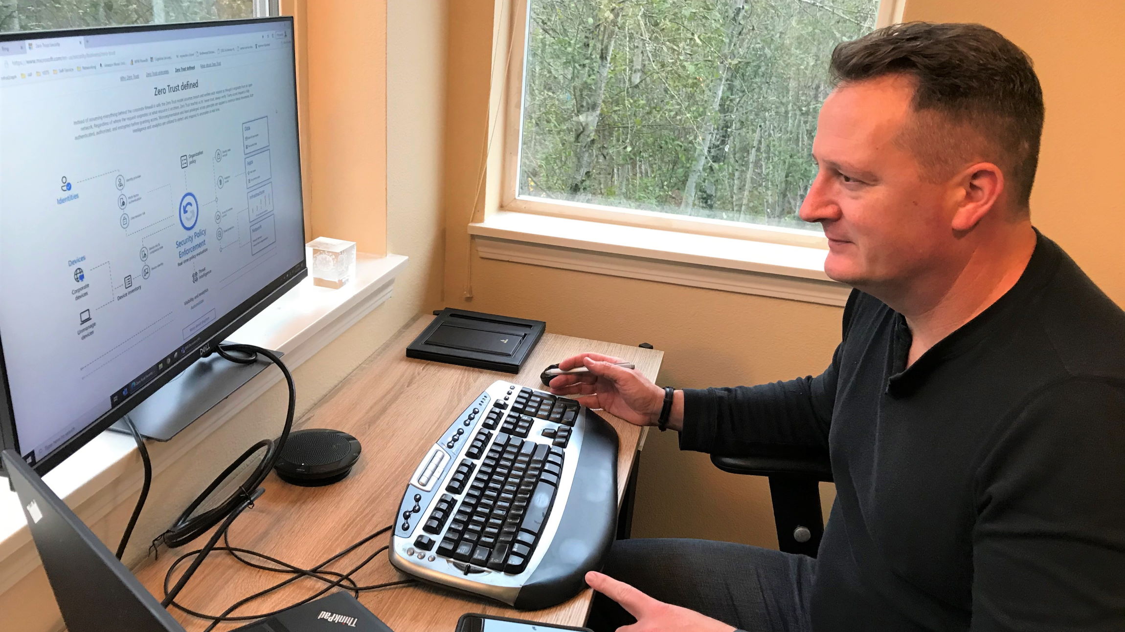Phil Suver sits at his desk and looks at his laptop.