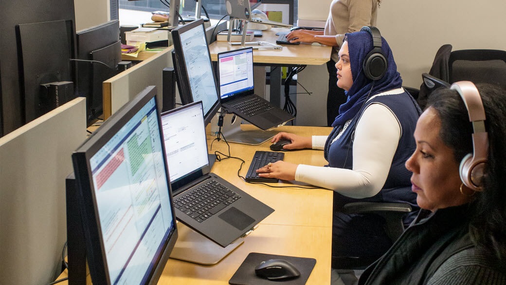 Female developers in focused work.
