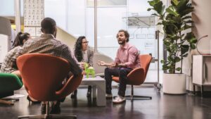 A group of employees collaborate in an open workspace.