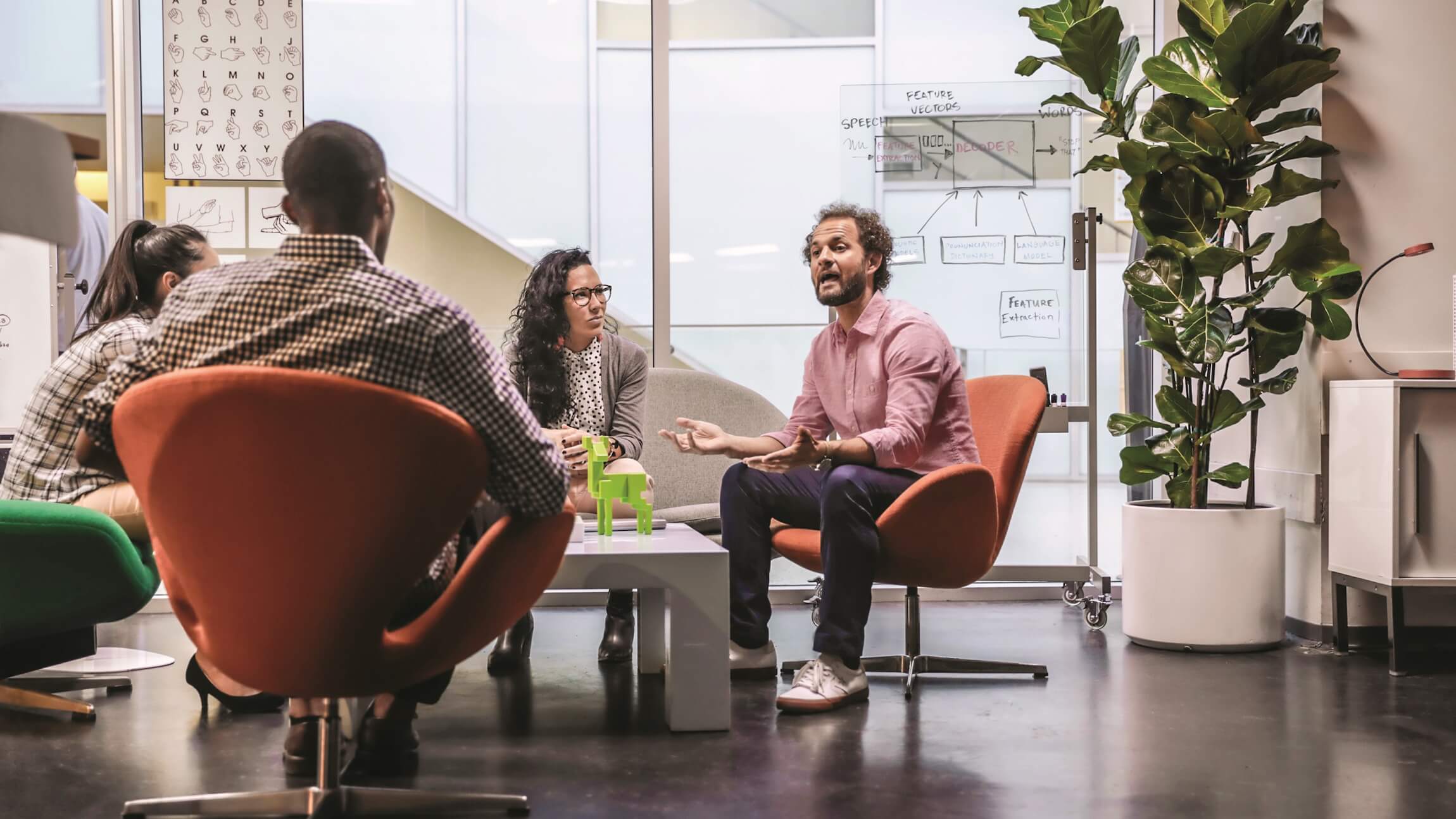 A group of employees collaborate in an open workspace.