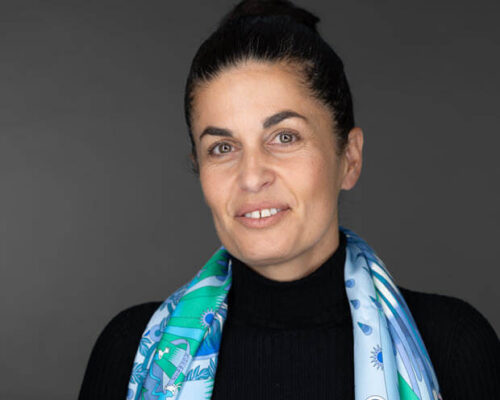 Sission smiles in a corporate photo. 